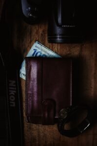brown leather bifold wallet on brown wooden table