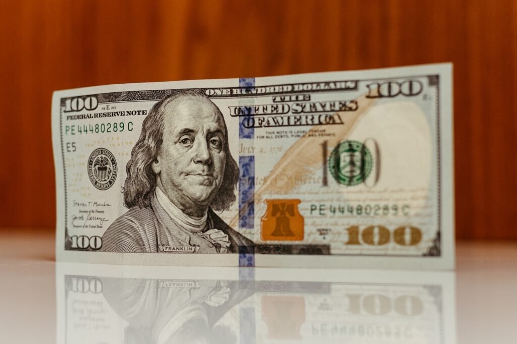 a one hundred dollar bill sitting on top of a table