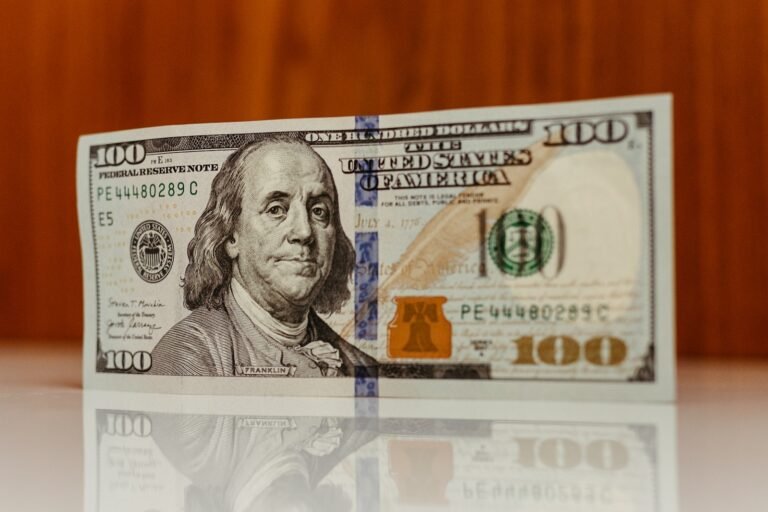 a one hundred dollar bill sitting on top of a table